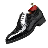 Black glossy dress shoe with a red and gold hanger on a dark background