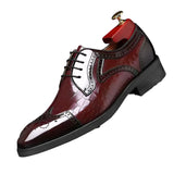 Red leather dress shoe with detailed design on a dark background
