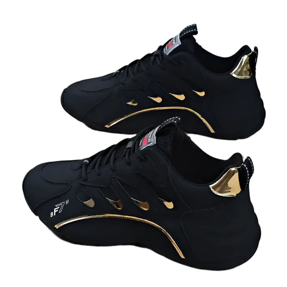Black sneakers with gold accents on a light wooden floor
