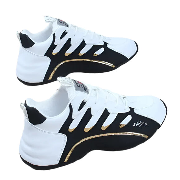 Black and white sneakers with gold accents on a wooden floor