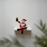 Red and White Resin Elderly Figure Ornament Seated Character Raising a Glass